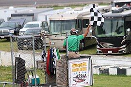 The flagman displays the checkered flag in 2018