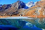 Snow-covered mountains and a lake in front