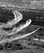 A U.S. Air Force Fairchild C-123 Provider aircraft crop-dusting in Vietnam during Operation Ranch Hand.