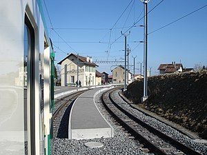 Double-track line next to a two-story station building