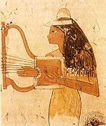 Musician wearing a perfume cone playing the lyre