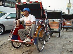 Becak and driver, Ciputat, South Tangerang, Indonesia.