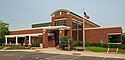 Edina Library, a brick building with an arched entryway and a rectangular concrete pavilion over the entrance