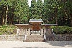 Wooden fence and gate among trees.