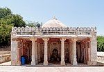 A stone mosque with white marble pillars