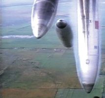 An overhead view of bombs falling over farmers' fields.