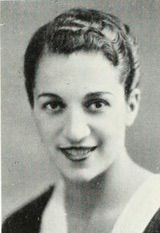 A photograph of a young smiling woman with short dark glossy hair and dark eyes.