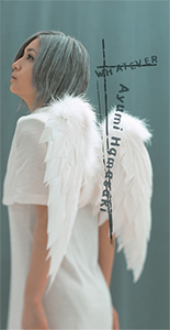 The picture has Ayumi Hamasaki wearing an Angel costume, with angel wings. She is pictured in front of a blue backdrop, alongside the text and her name superimposed on the image.