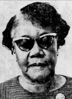 An older African-American woman wearing dark cat-eye glasses. Her hair is short and parted on the side.