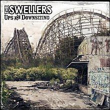 An abandoned theme park with a wooden roller coaster in the background