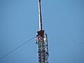 A detailed view of the guy wires and top part of the mast.