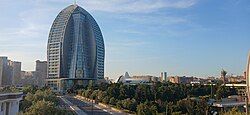 A photograph showing the Ritz-Carlton Baku Hotel, which is shaped like a sail.