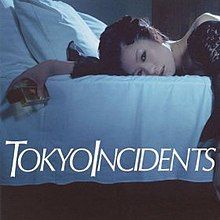 A woman lies on a bed in a black dress, her hand holding a perfume bottle that says "Adult". In front of her are the words "Tokyo Incidents" in white.