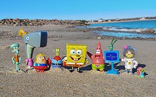 Photograph of a SpongeBob SquarePants figure set on a beach