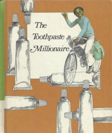 drawing of a young black male child riding a bicycle and waving. There are tubes of toothpaste around the border of the cover