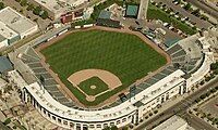 Sky view of a white baseball stadium with green seats