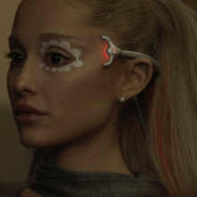 Cover art for "We Can't Be Friends (Wait for Your Love)": Ariana Grande wearing a mind-erasing device, with a sad look on her face