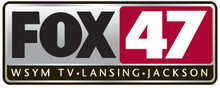 Inside a silver rounded rectangle trimmed in black, from upper left: The Fox network logo in black on silver; a red box containing a white, bold numeral 47; a black box containing the words "W S Y M TV • LANSING • JACKSON" in a sans serif.