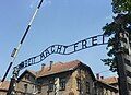 The entry gate to Auschwitz concentration camp, with the infamous "ARBEIT MACHT FREI" message clearly visible.