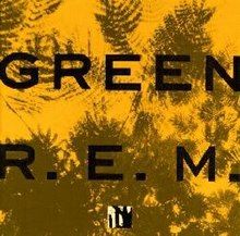 A golden yellow background with dark green impressions of leaves on it and the words "GREEN" and "R.E.M." written on top in black