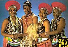 Mahlathini and the Mahotella Queens, 1988. (L to r): Hilda Tloubatla, Mahlathini, Nobesuthu Mbadu, and Mildred Mangxola.