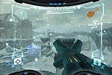 A video game screenshot. A weapon points outwards towards a snowy landscape.