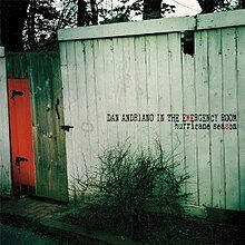 A photograph of a run-down wooden shack with a red door with "DAN ANDRIANO IN THE EMERGENCY ROOM hurricane season" written over it black. The 'M' in "emergency" and the second 'S' in "season" are coloured red