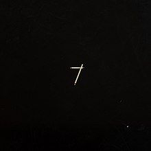 A black cover with two matchsticks making a "7" on it