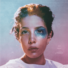 A photo of Halsey's face with thick blue glittery makeup around her left eye