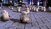 Many alien adipose on a street.