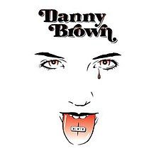 A drawing of a face on a plain white background. The drawing is monochrome, with some elements painted in red. Its mouth is opened, showing a pill labelled "XXX" placed on the tongue. There is a single red tear under one of the eyes. Above the face is the text "Danny Brown".