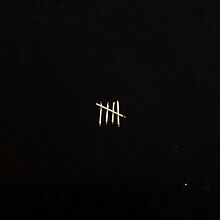 A black cover with a scratchy five match sticks in the shape of hatch marks on it